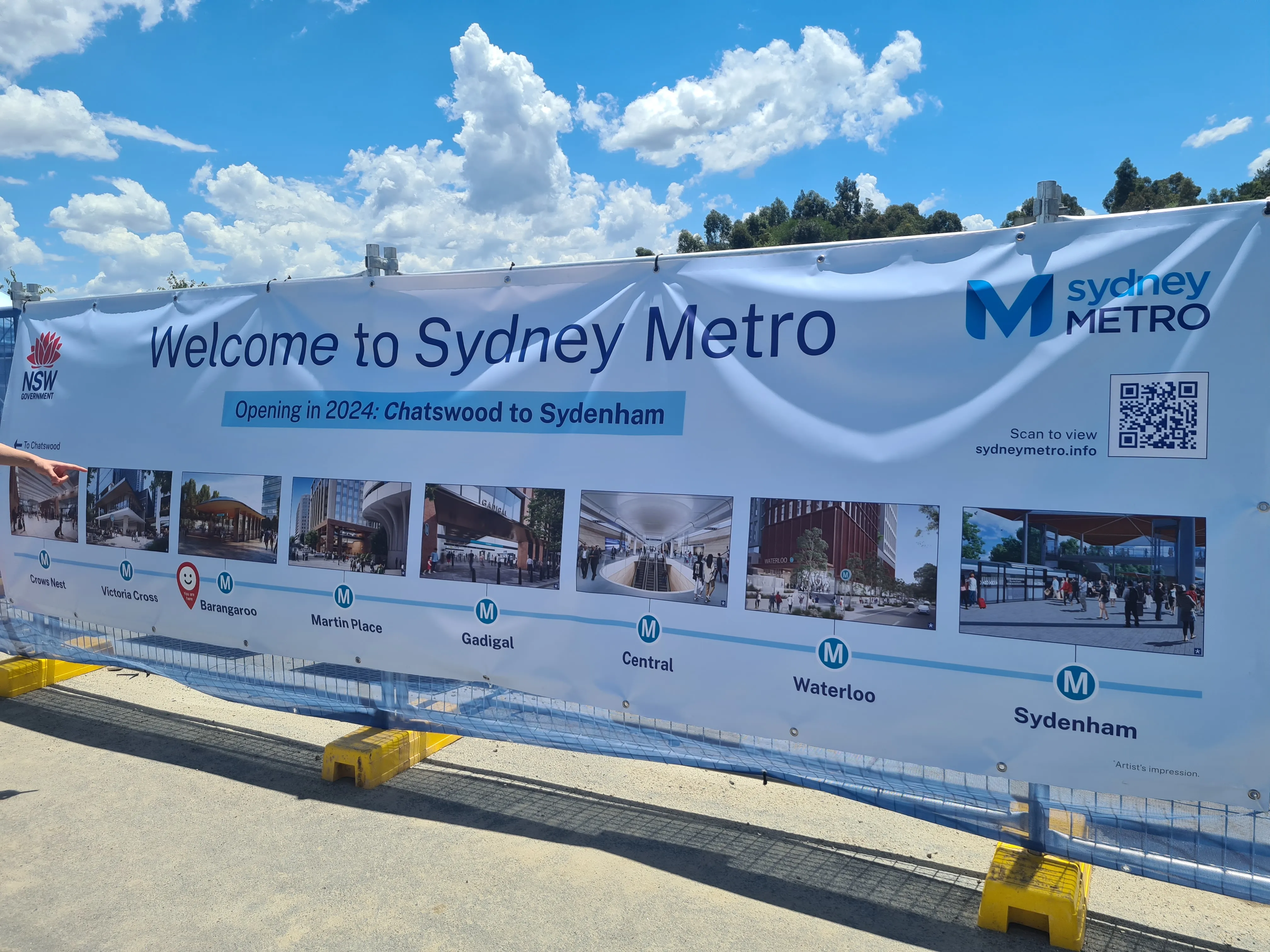 A Welcome banner placed in front of the station entrance, with the under-construction route of the Metro extension from Chatswood to Sydenham.